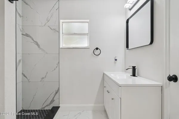 a bathroom with a sink a mirror and vanity