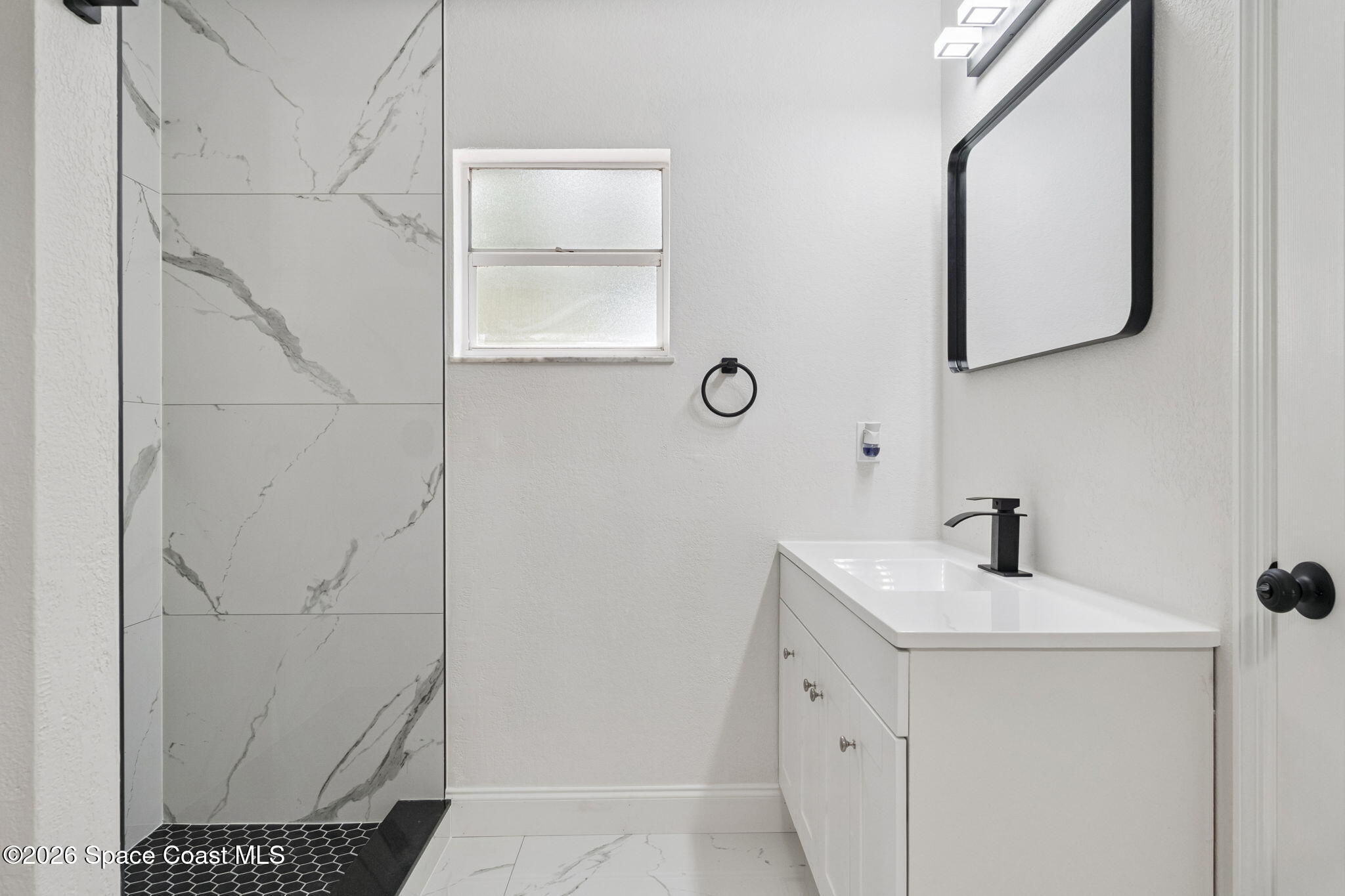 2665 Myrtle Avenue Mims, FL 32754 - Photo 17 of 23 a bathroom with a sink a mirror and vanity