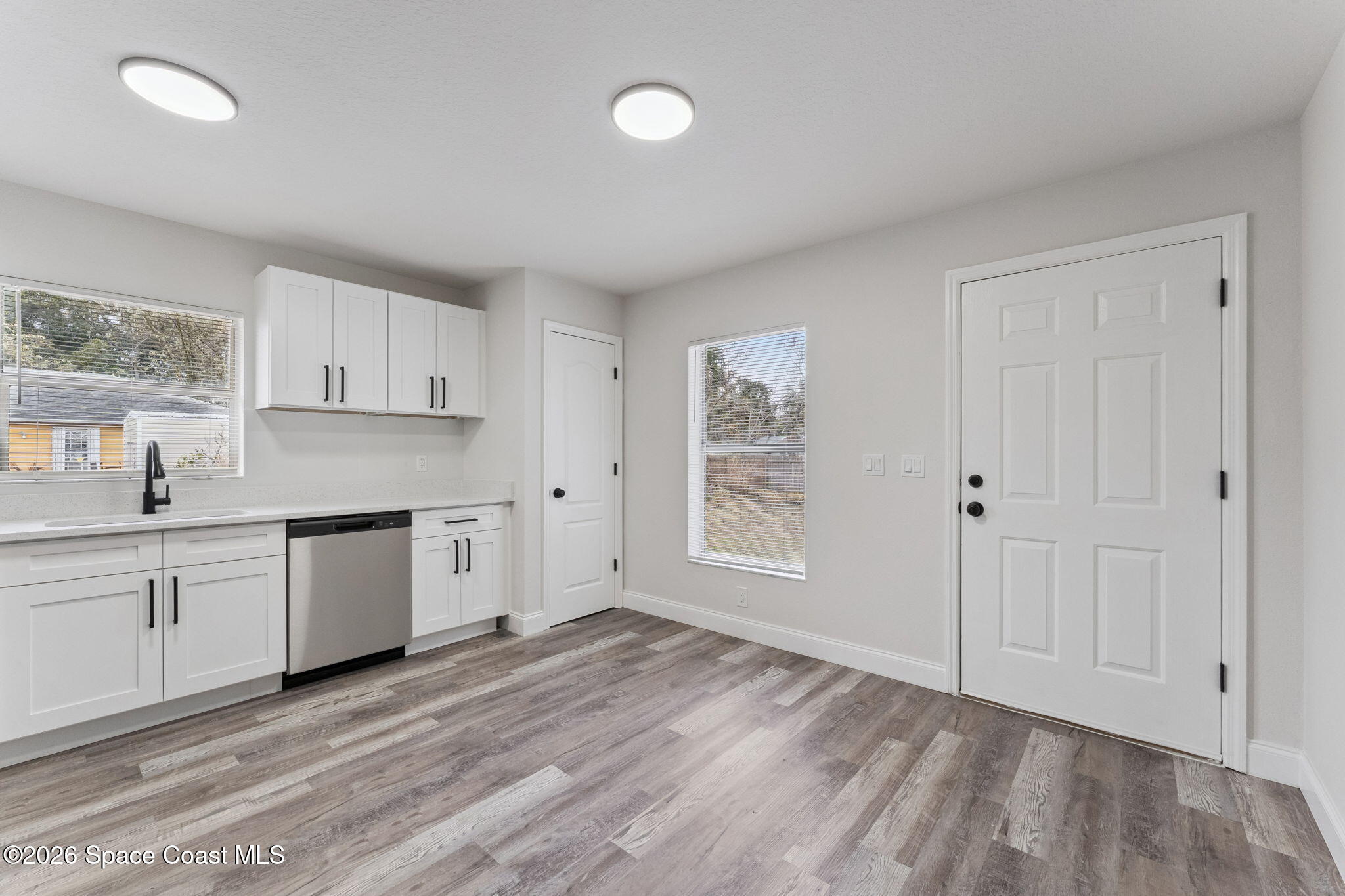 2665 Myrtle Avenue Mims, FL 32754 - Photo 9 of 23 a kitchen with granite countertop white cabinets and white appliances