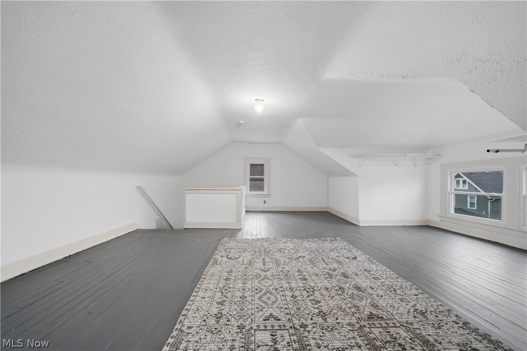 225 Cranz Place Akron, OH 44310 - Photo 15 of 34 Additional living space with dark wood finished floors, a textured ceiling, and lofted ceiling