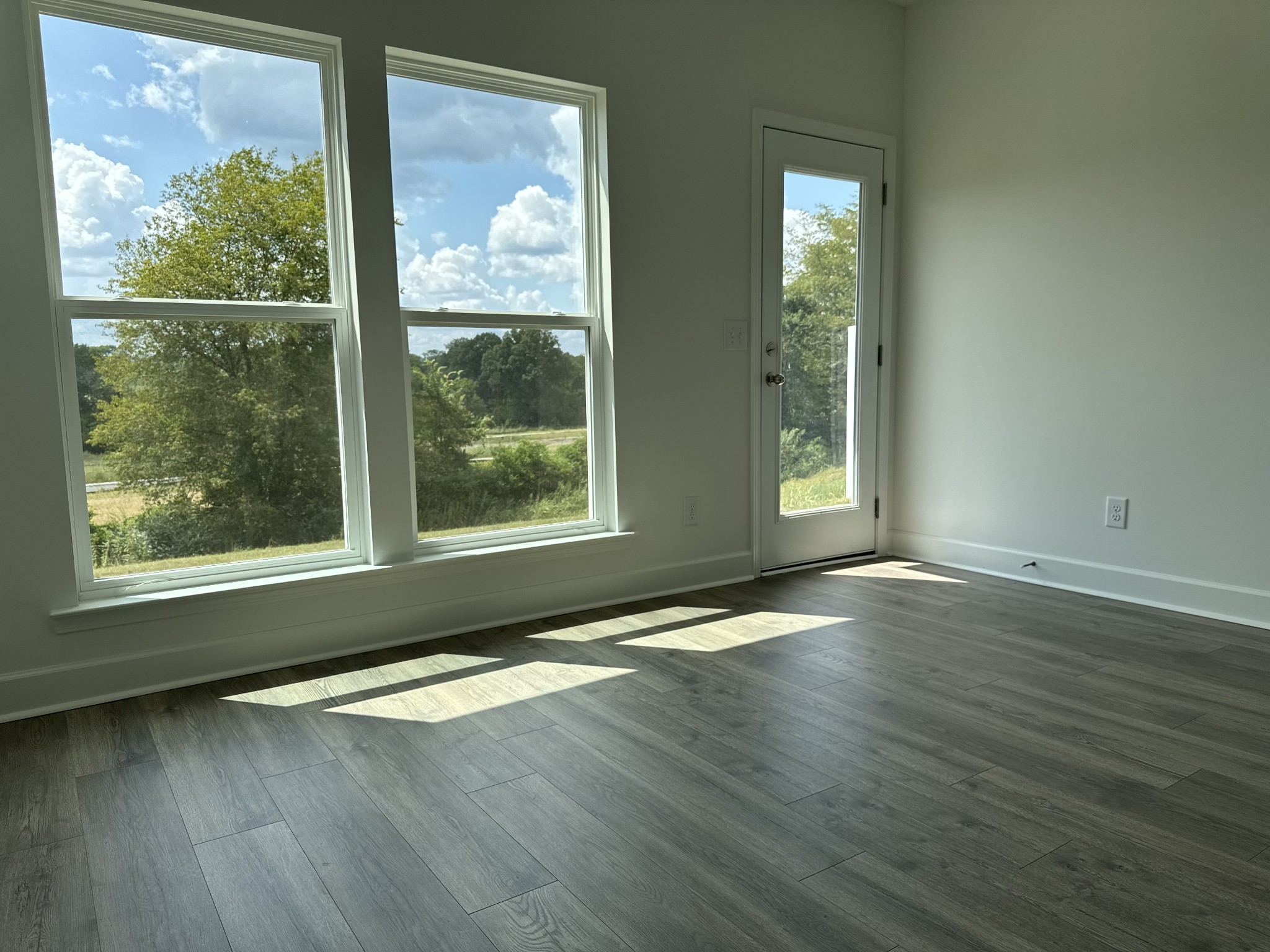 1120 June Wilde Ridge Spring Hill, TN 37174 - Photo 7 of 15 an empty room with wooden floor and windows