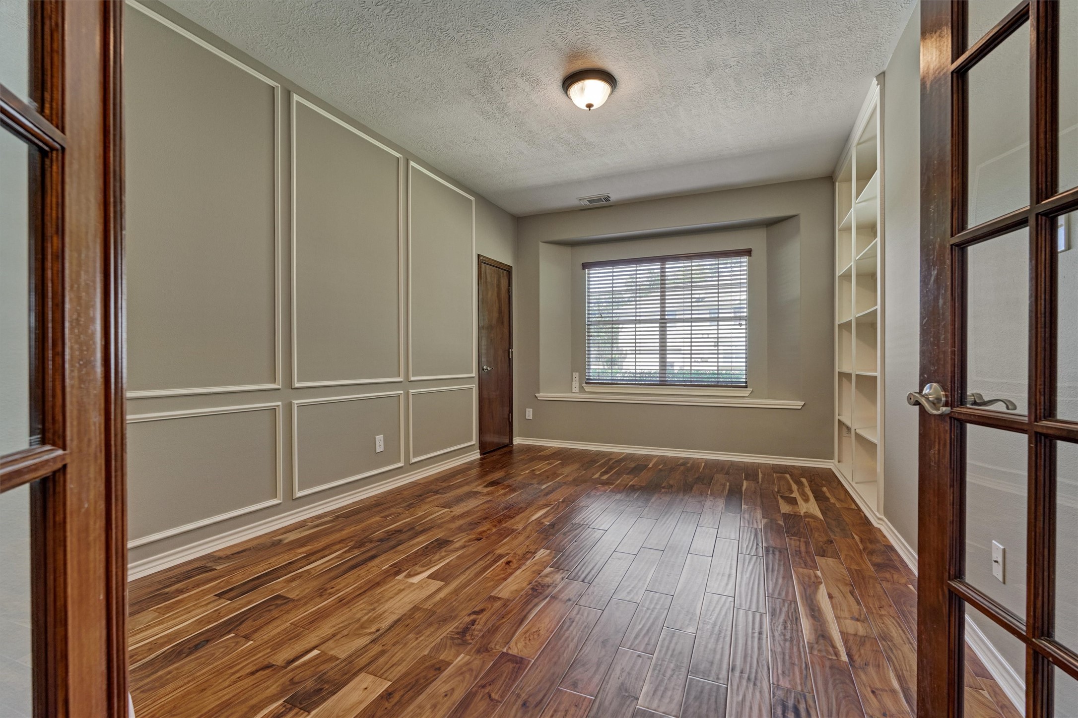 30202 West Legends Trail Drive Spring, TX 77386 - Photo 25 of 50 The large home office with warm hardwood floors, built in bookcases and double glass french doors.