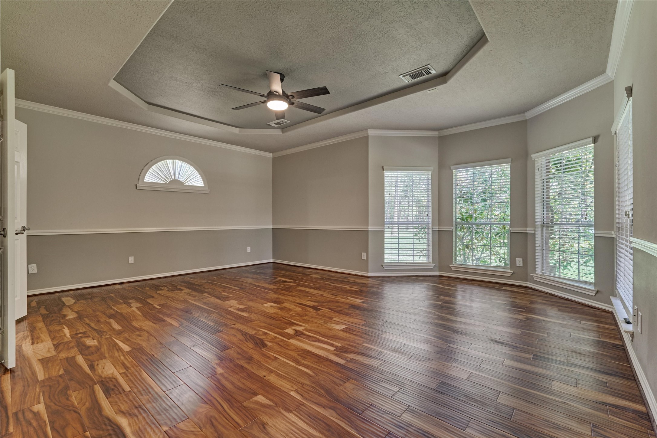 30202 West Legends Trail Drive Spring, TX 77386 - Photo 27 of 50 Wow! This is a spectacular primary suite with a beautiful bay window, trayed ceiling and gorgeous wood floors. Enjoy the stunning sunrise from this luxurious retreat.