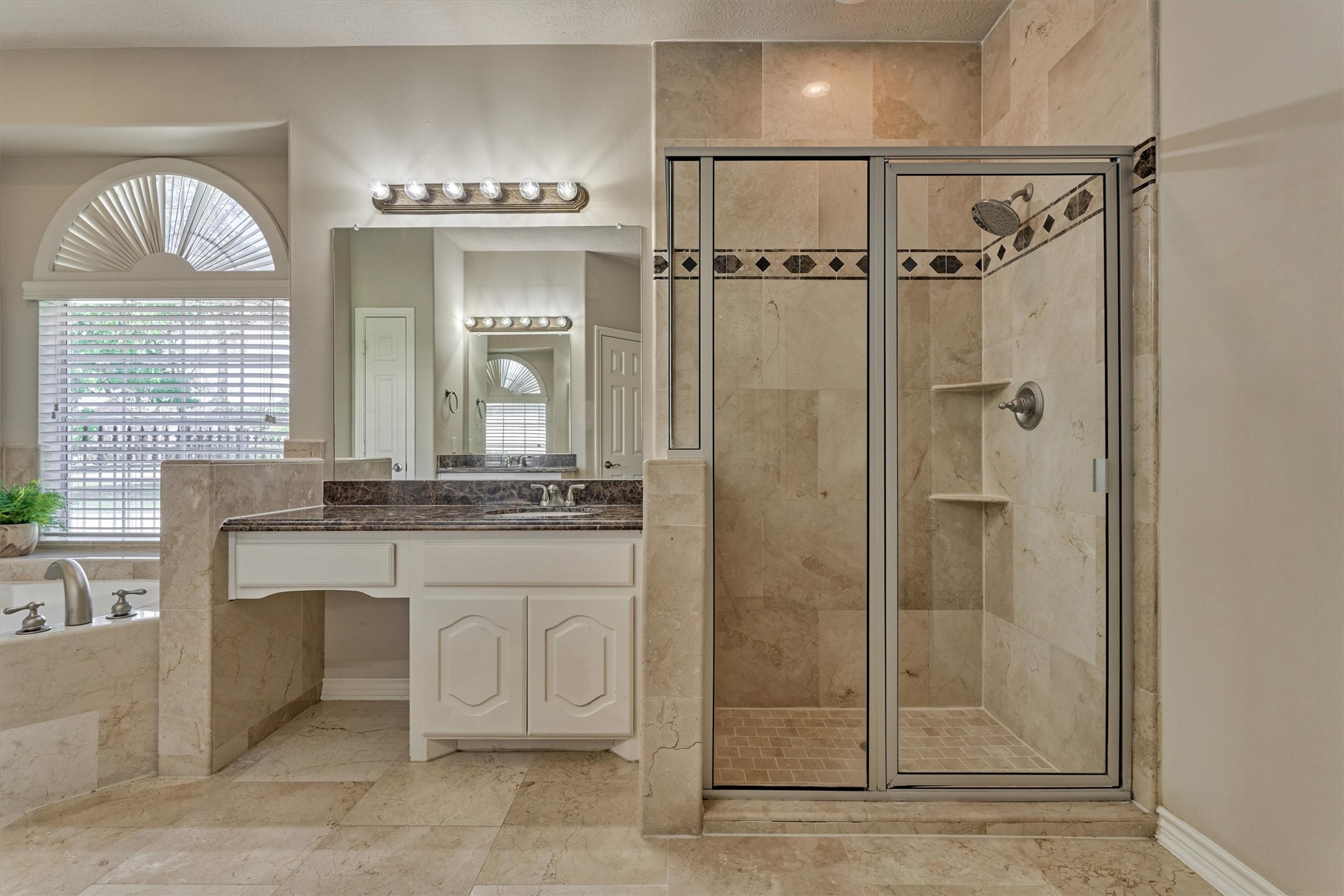30202 West Legends Trail Drive Spring, TX 77386 - Photo 30 of 50 The en-suite primary bathroom with oversized walk-in shower, granite counters, soaker tub and beautiful stone floors.