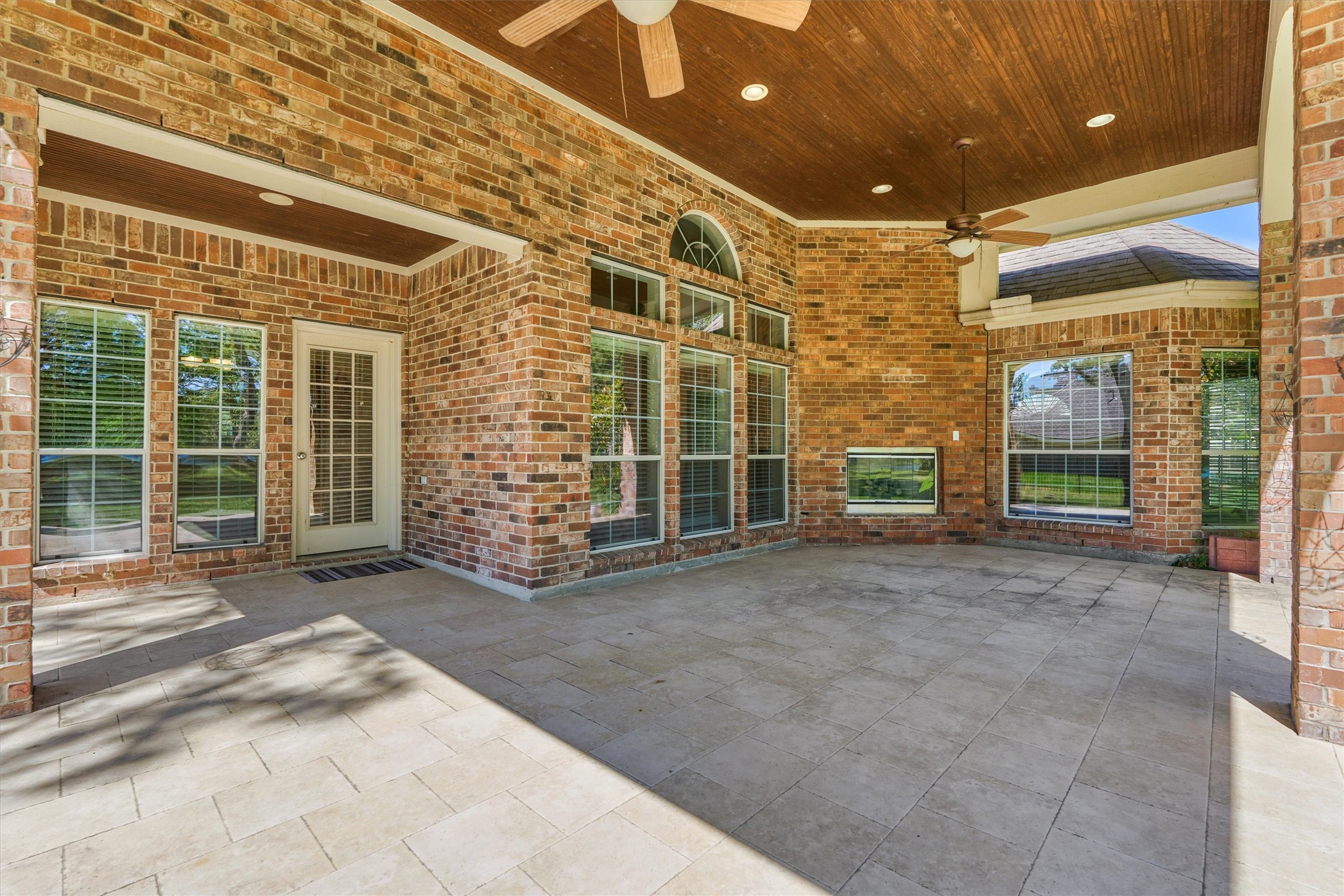 30202 West Legends Trail Drive Spring, TX 77386 - Photo 40 of 50 Wow! Enjoy this huge, covered lanai with outdoor gas fireplace, stained ceiling and beautiful brick columns.