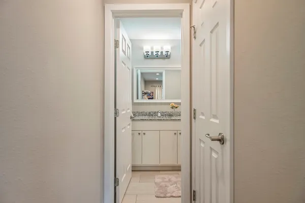 a bathroom with a sink a toilet a mirror a vanity and shower