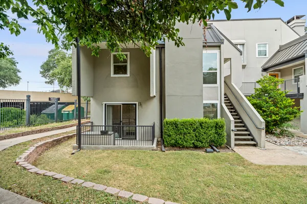 a view of a house with backyard and sitting area