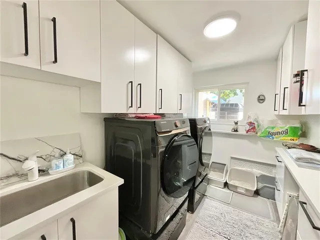 a large bedroom with a bed and a flat screen tv