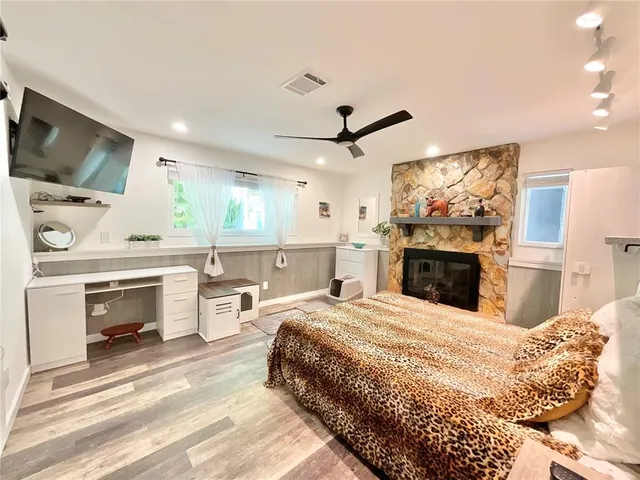 a bedroom with a bed and a flat tv screen on the dresser