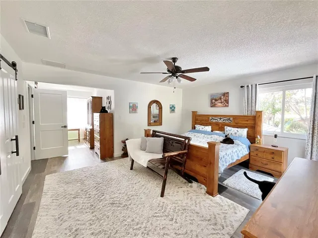 a view of an outdoor dining space with furniture and umbrella