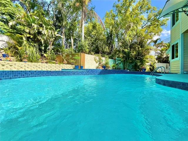 a view of a chairs and table in backyard of the house