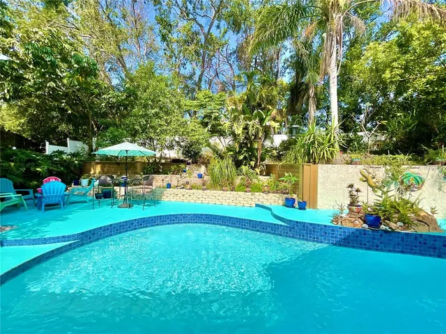 an aerial view of a house with a yard and lake view