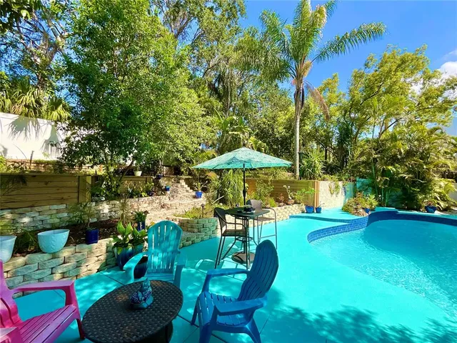 an aerial view of residential houses with outdoor space and street view