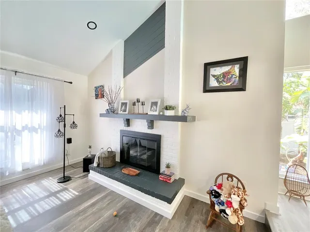 a view of a dining room and livingroom with furniture wooden floor a chandelier