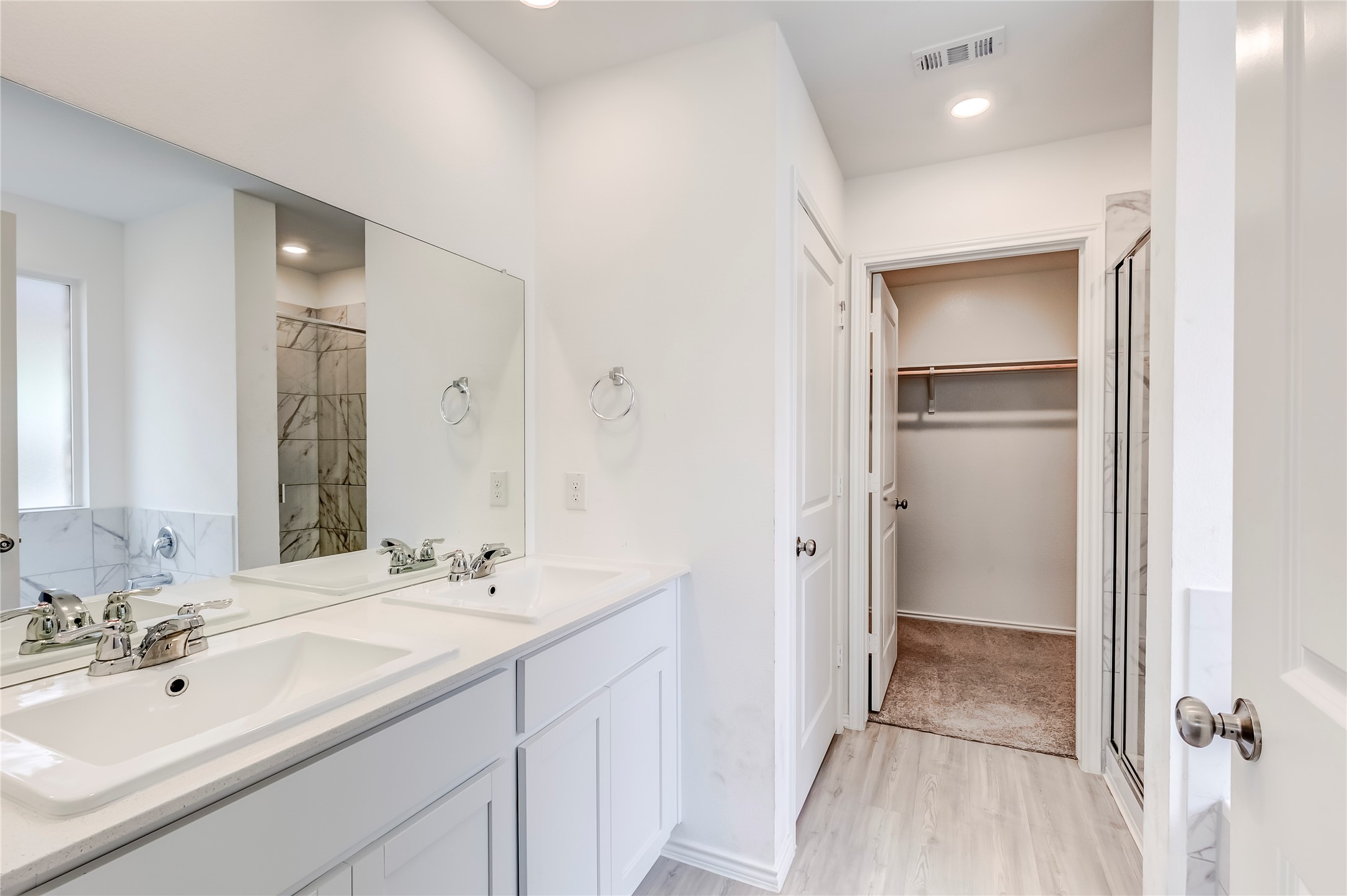 591 Avre Loop Kyle, TX 78640 - Photo 21 of 34 a spacious bathroom with a double vanity sink a mirror and shower