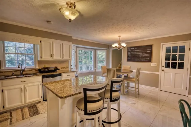 a view of a dining room with furniture and chandelier