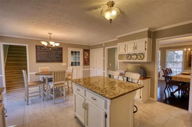 a view of a dining room with furniture large windows and wooden floor