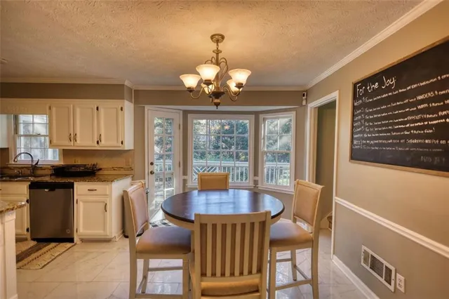 a living room with stainless steel appliances kitchen island granite countertop furniture and a flat screen tv
