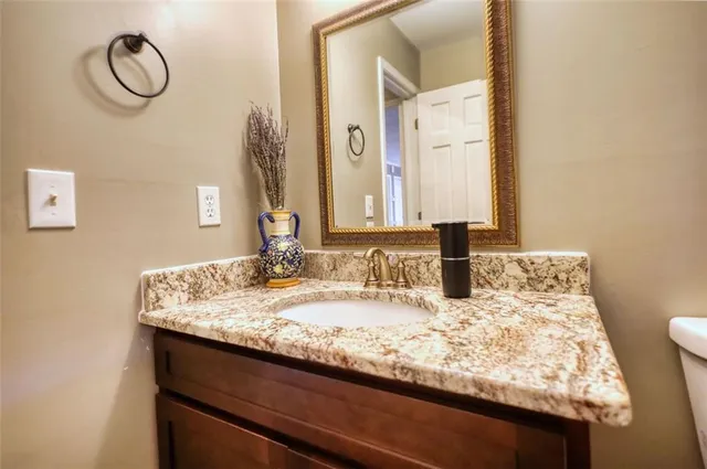 a bedroom with a bed and a chandelier fan