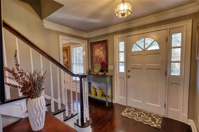 a view of an entryway with wooden floor
