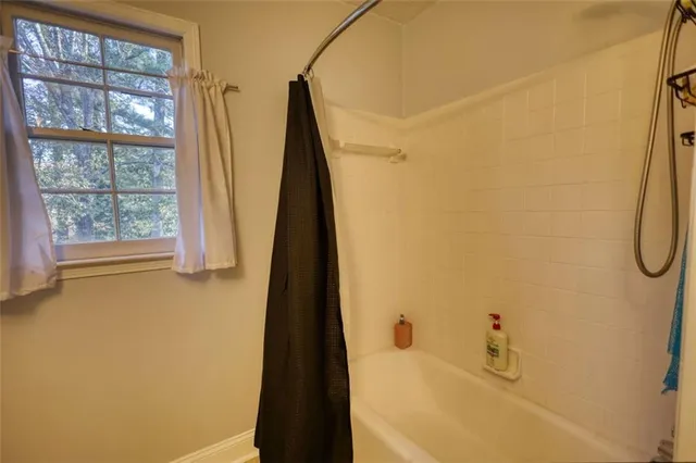 a bathroom with a granite countertop double vanity and a mirror