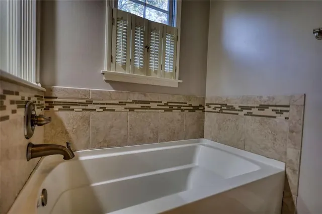 a view of a house with a large window and wooden floor