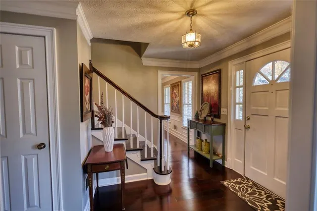 a view of entryway with stairs and wooden floor