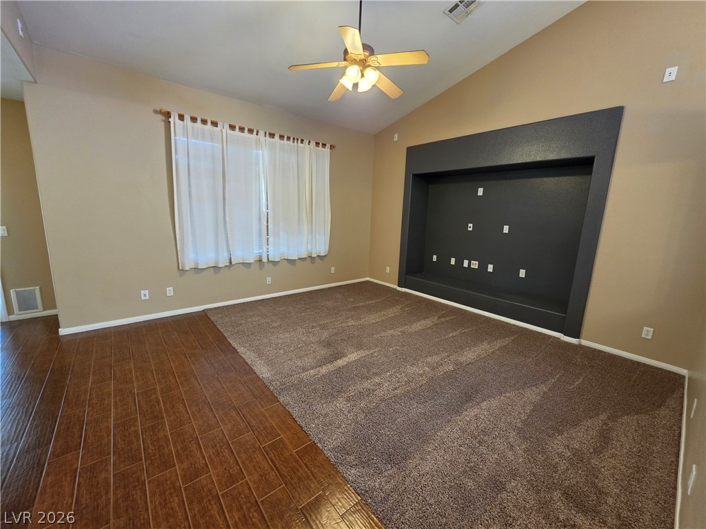 209 Opera House Street Henderson, NV 89012 - Photo 11 of 45 Vaulted ceilings and a built-in media alcove highlight this spacious living area.