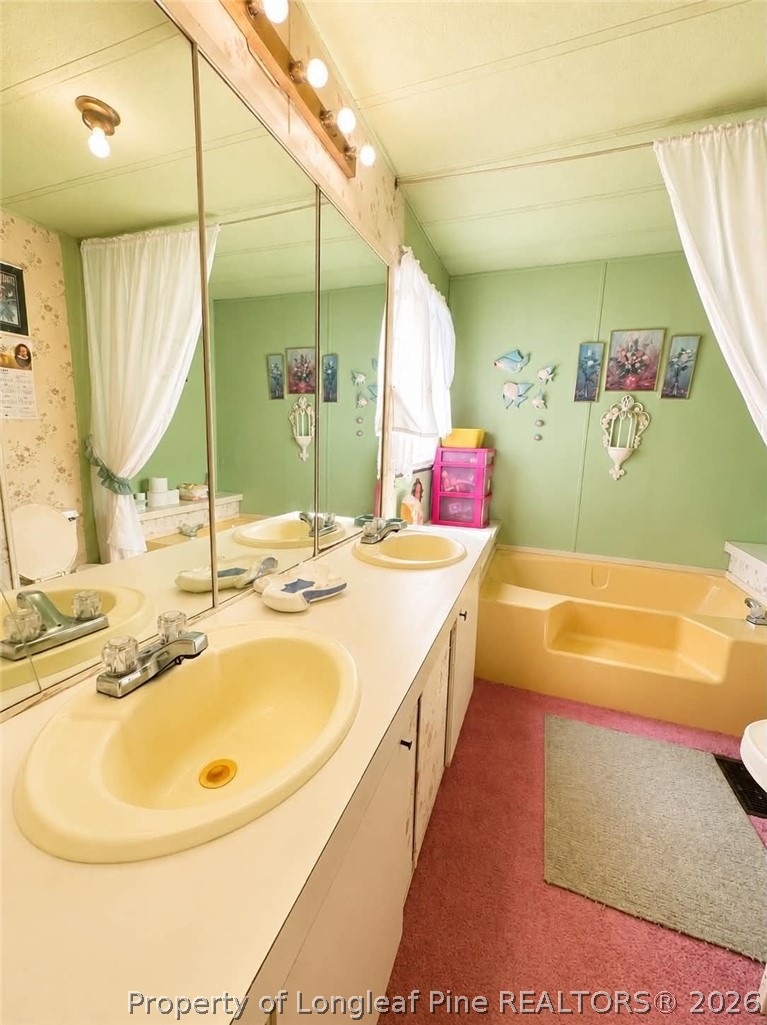 4435 Tartt's Mill Road Wilson, NC 27893 - Photo 12 of 23 a bathroom with a tub sink and mirror