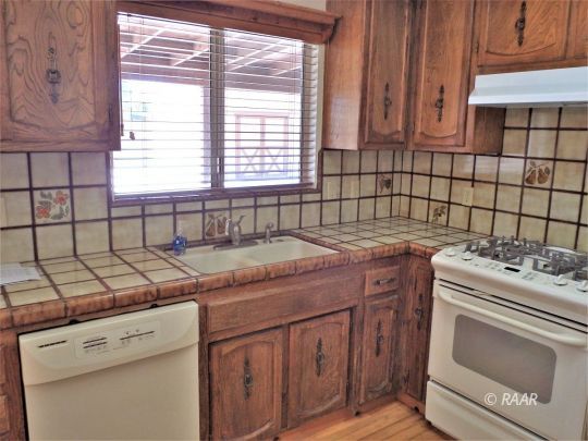 601 Weiman Avenue Ridgecrest, CA 93555 - Photo 15 of 35 a kitchen with a stove sink and cabinets