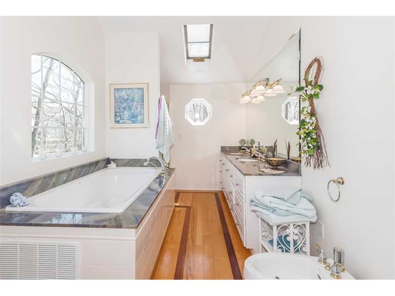 65 Lockwood Lane Riverside, CT 06878 - Photo 14 of 25 a spacious bathroom with a tub double vanity and a window