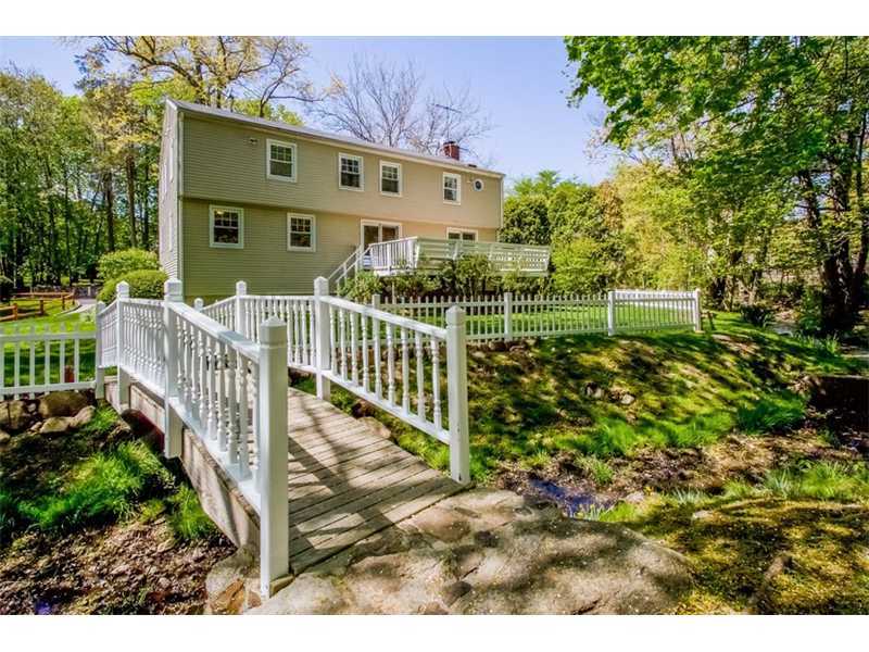 65 Lockwood Lane Riverside, CT 06878 - Photo 3 of 25 a view of a house with a small yard and wooden fence