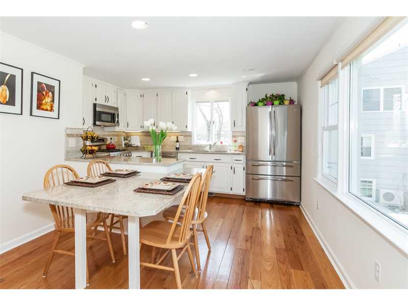 65 Lockwood Lane Riverside, CT 06878 - Photo 9 of 25 a kitchen with a table chairs refrigerator and microwave
