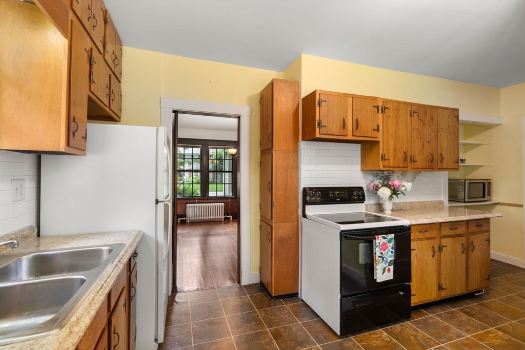 81 Avalon Road Newton, MA 02468 - Photo 12 of 38 a kitchen with a sink stove and cabinets
