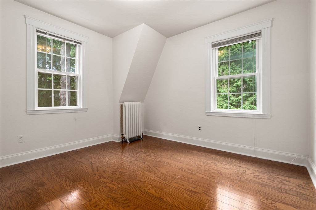 81 Avalon Road Newton, MA 02468 - Photo 25 of 38 an empty room with wooden floor and windows