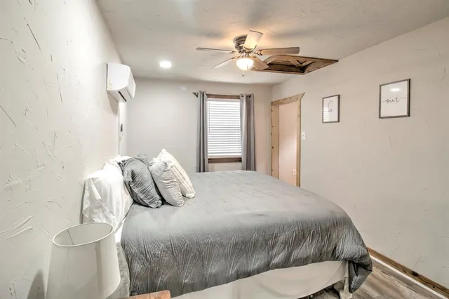 a bedroom with a bed and a chandelier