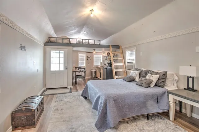 a bedroom with a large bed and a window