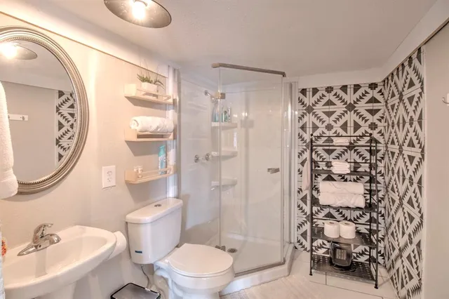 a bathroom with a toilet sink and shower