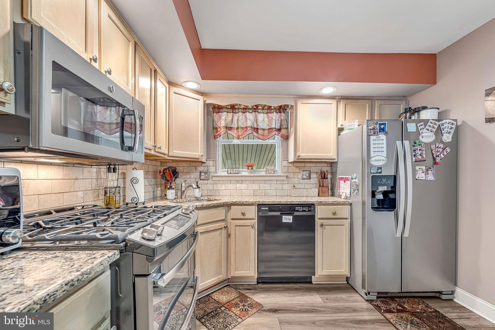 301 North Coles Avenue Maple Shade, NJ 08052 - Photo 11 of 31 a kitchen with stainless steel appliances granite countertop a stove a sink and a refrigerator