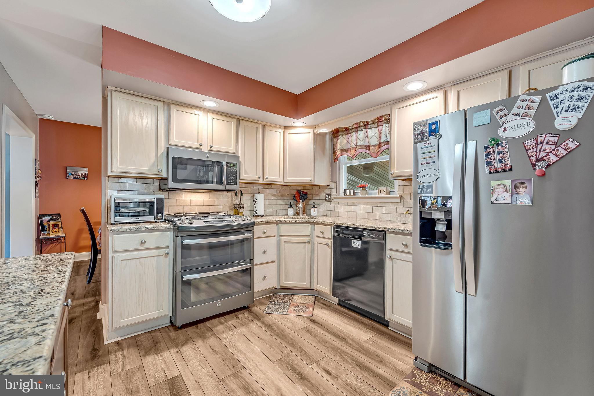 301 North Coles Avenue Maple Shade, NJ 08052 - Photo 12 of 31 a kitchen with stainless steel appliances granite countertop a refrigerator a stove top oven a sink and dishwasher