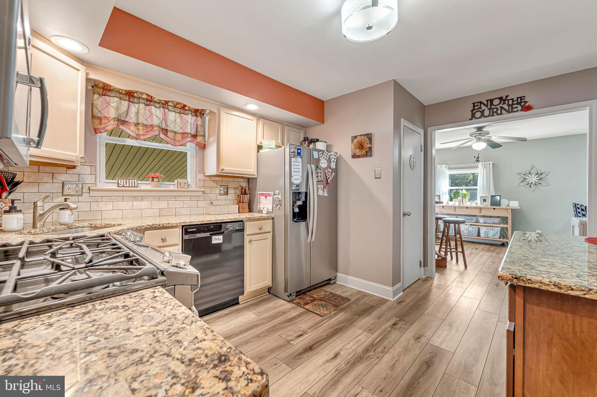 301 North Coles Avenue Maple Shade, NJ 08052 - Photo 13 of 31 a kitchen with granite countertop a stove a sink and a refrigerator