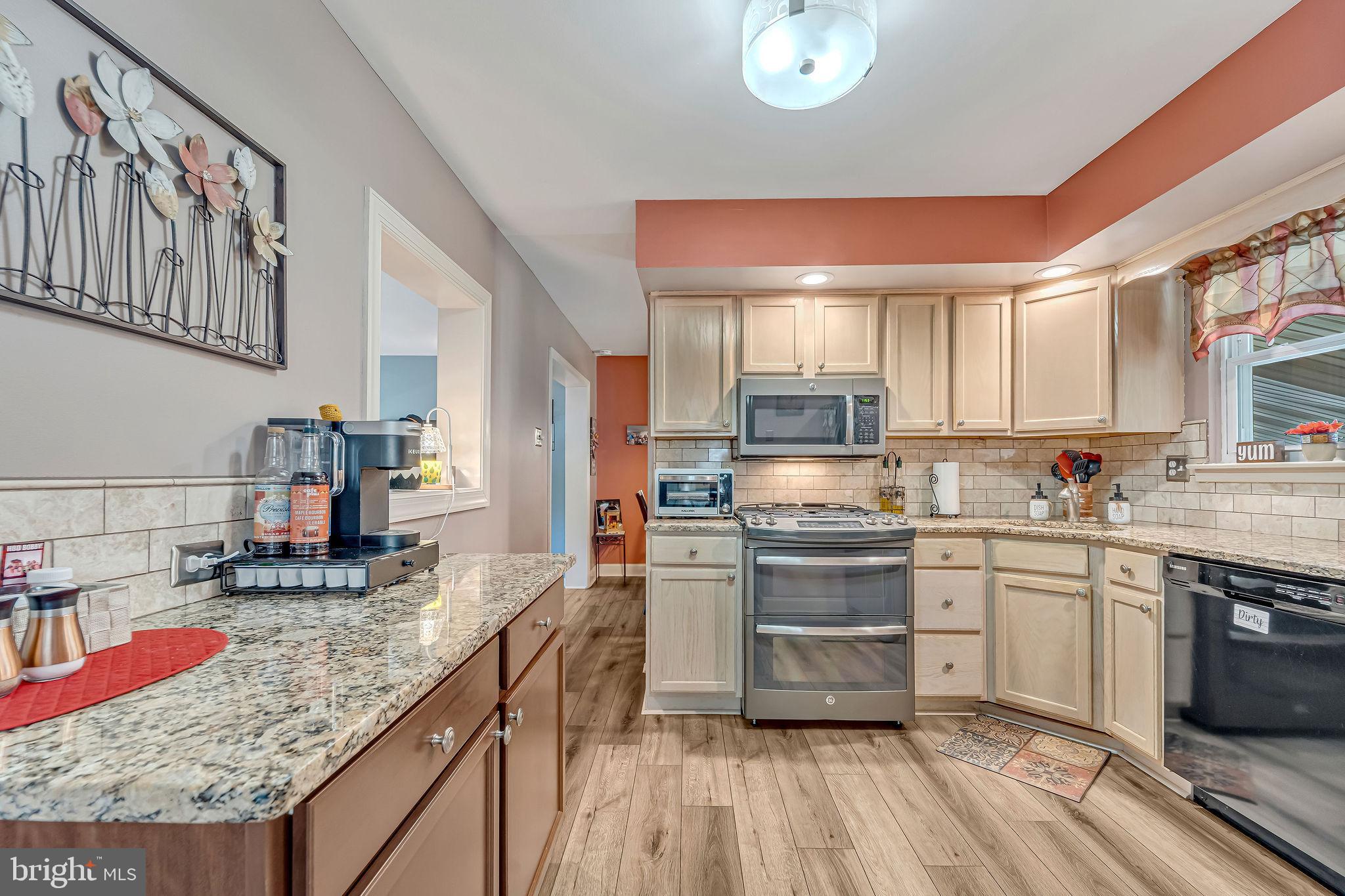 301 North Coles Avenue Maple Shade, NJ 08052 - Photo 14 of 31 a kitchen with stainless steel appliances granite countertop a stove and cabinets