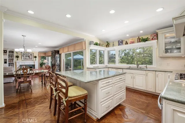 a kitchen with stainless steel appliances granite countertop lots of counter top and couches