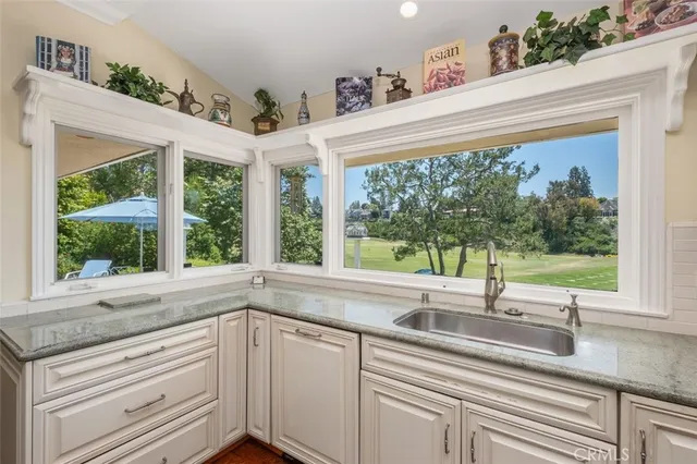 a kitchen with a sink and large window