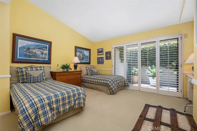 a bedroom with a bed next to a window