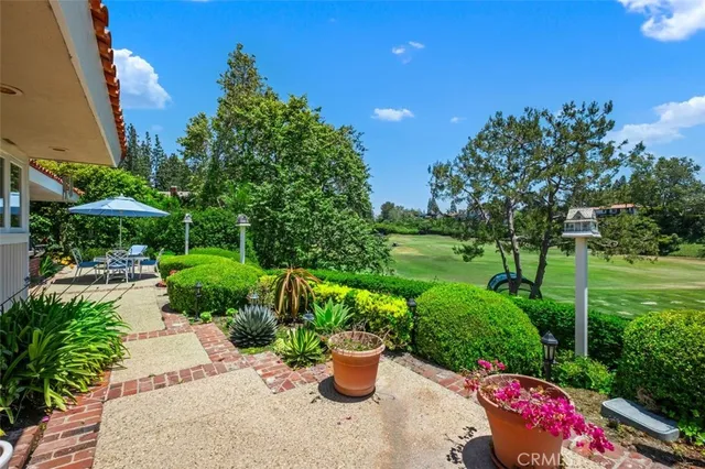 a view of a patio with a table and chairs under an umbrella