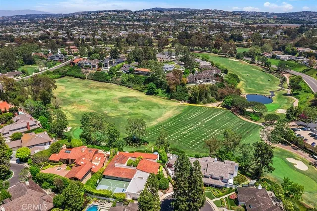 an aerial view of a house with swimming pool patio and outdoor seating