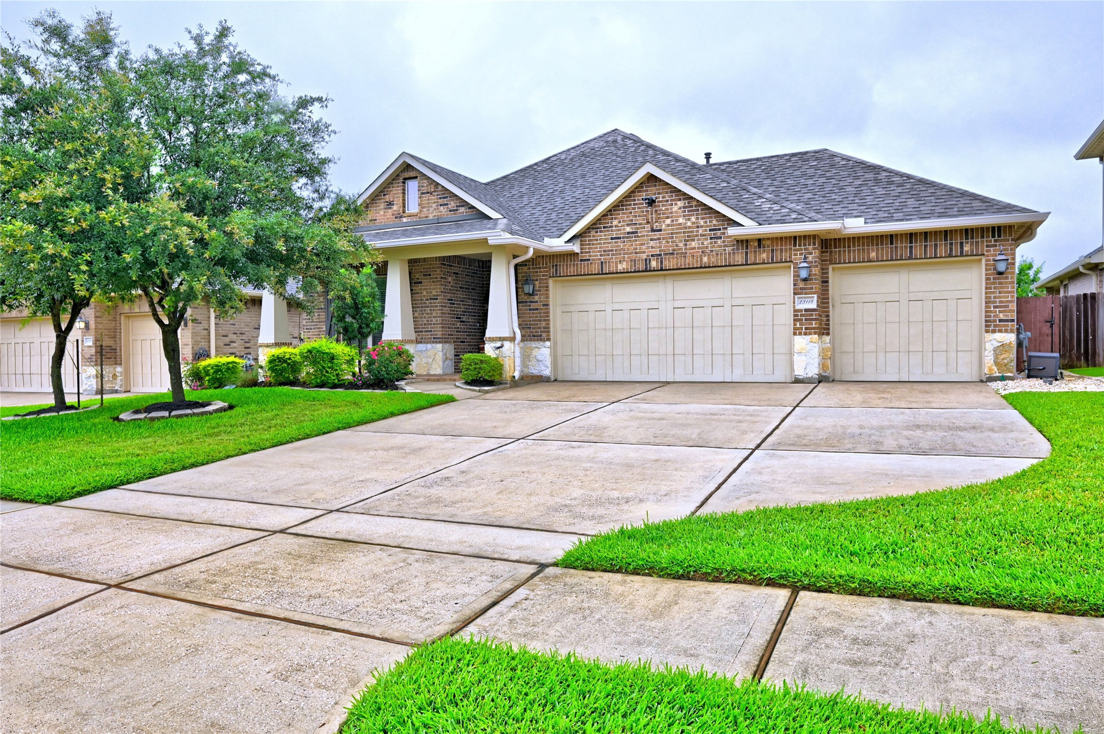 23118 Southern Brk Trail Spring, TX 77389 - Photo 2 of 50 The home has a mixed media elevation of brick, stone and hardi plank. The third car driveway provides additional parking. I love the sidewalks in this neighborhood.