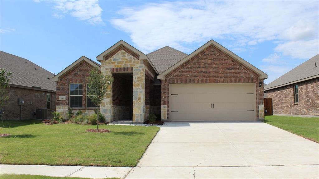512 Range Road Caddo Mills, TX 75135 - Photo 1 of 33 Brick and stone facade residence featuring an attached two-car garage