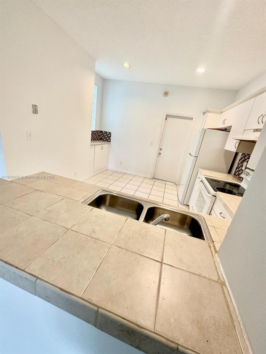 The Ridges Weston, FL 33331 - Photo 13 of 54 a kitchen with a sink and a refrigerator